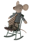 A Maileg fabric mouse doll with large ears, plaid shirt, patterned tie, and checkered pants sits in the Maileg Rocking Chair—a charming accent for your living room décor.