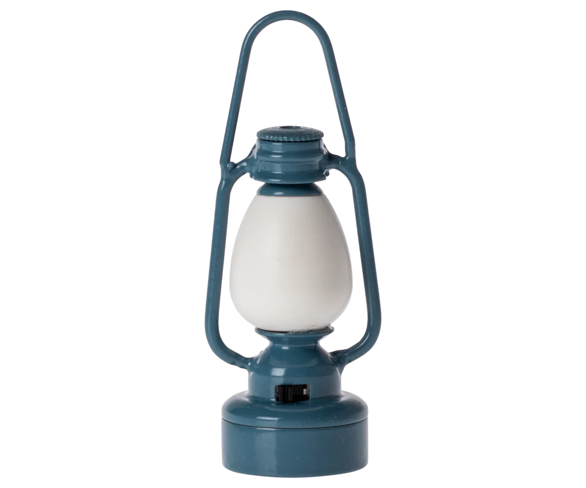 The Maileg Furniture blue vintage-style lantern by Maileg features a white glass center and handle, ideal for dollhouse décor or Maileg Mouse, shown upright on a plain white background.