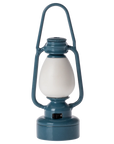 The Maileg Furniture blue vintage-style lantern by Maileg features a white glass center and handle, ideal for dollhouse décor or Maileg Mouse, shown upright on a plain white background.