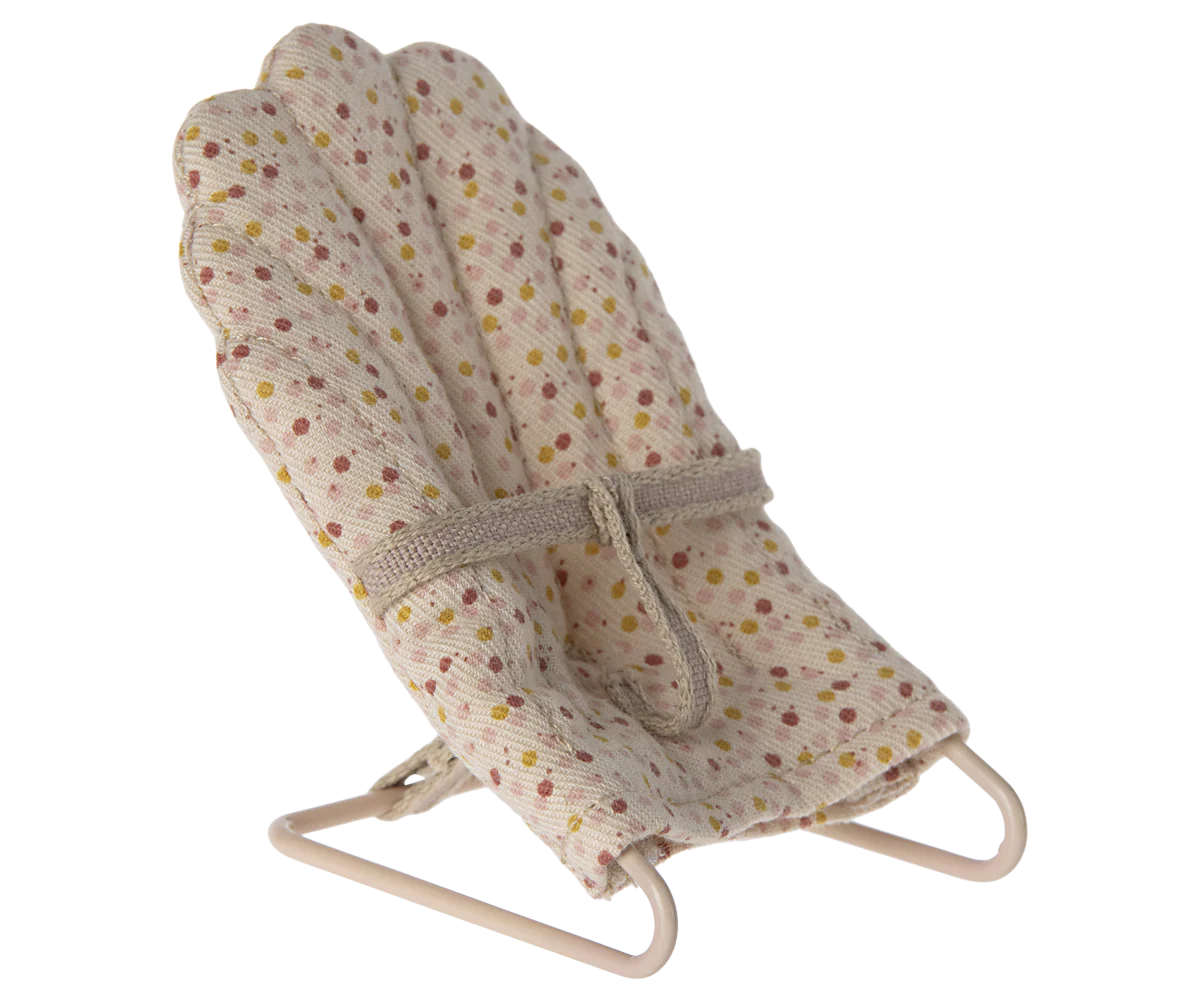 The Maileg My Babysitter by Maileg is a small, fabric-covered doll chair with a metal base, a beige seat with colorful dots, and an attached strap—perfect for keeping dolls secure and comfy.