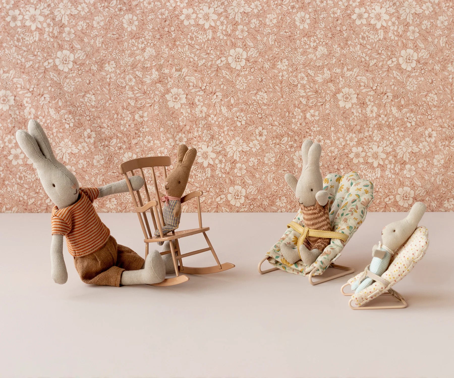 Maileg bunnies on Micro Babysitter seats with floral wallpaper, playful nursery decor from Bungalow Furniture &amp; Accessories.
