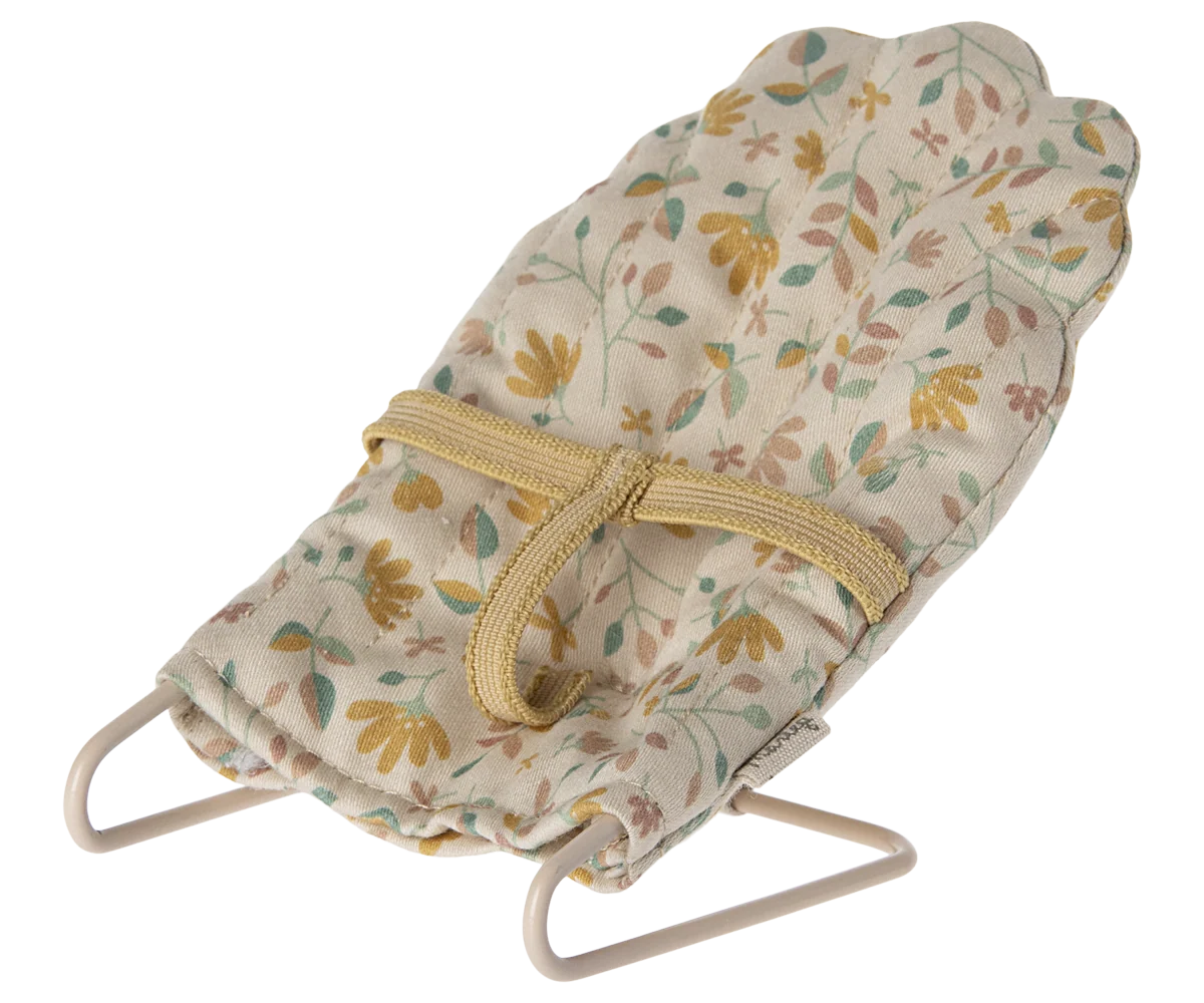 Floral fabric baby doll seat with yellow strap and metal frame, Maileg Micro Babysitter by Maileg.