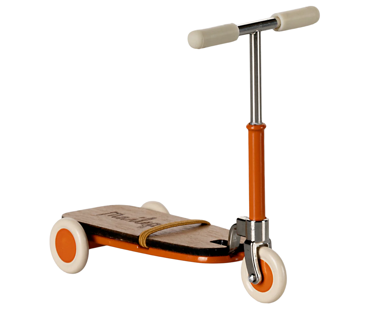 The Maileg Kick Board by Maileg is a vintage-style children's scooter featuring wooden details, an orange frame, white handlebars, and three white wheels, displayed against a plain background.