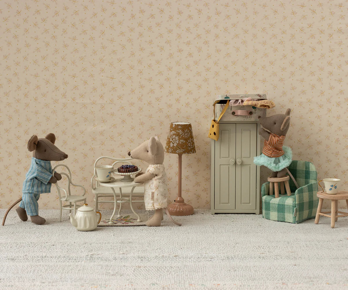 Maileg Café Set Small with mice figures enjoying tea in a cozy playroom scene, one reaching for a box on the cabinet.