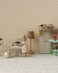 Maileg Café Set Small with mice figures enjoying tea in a cozy playroom scene, one reaching for a box on the cabinet.