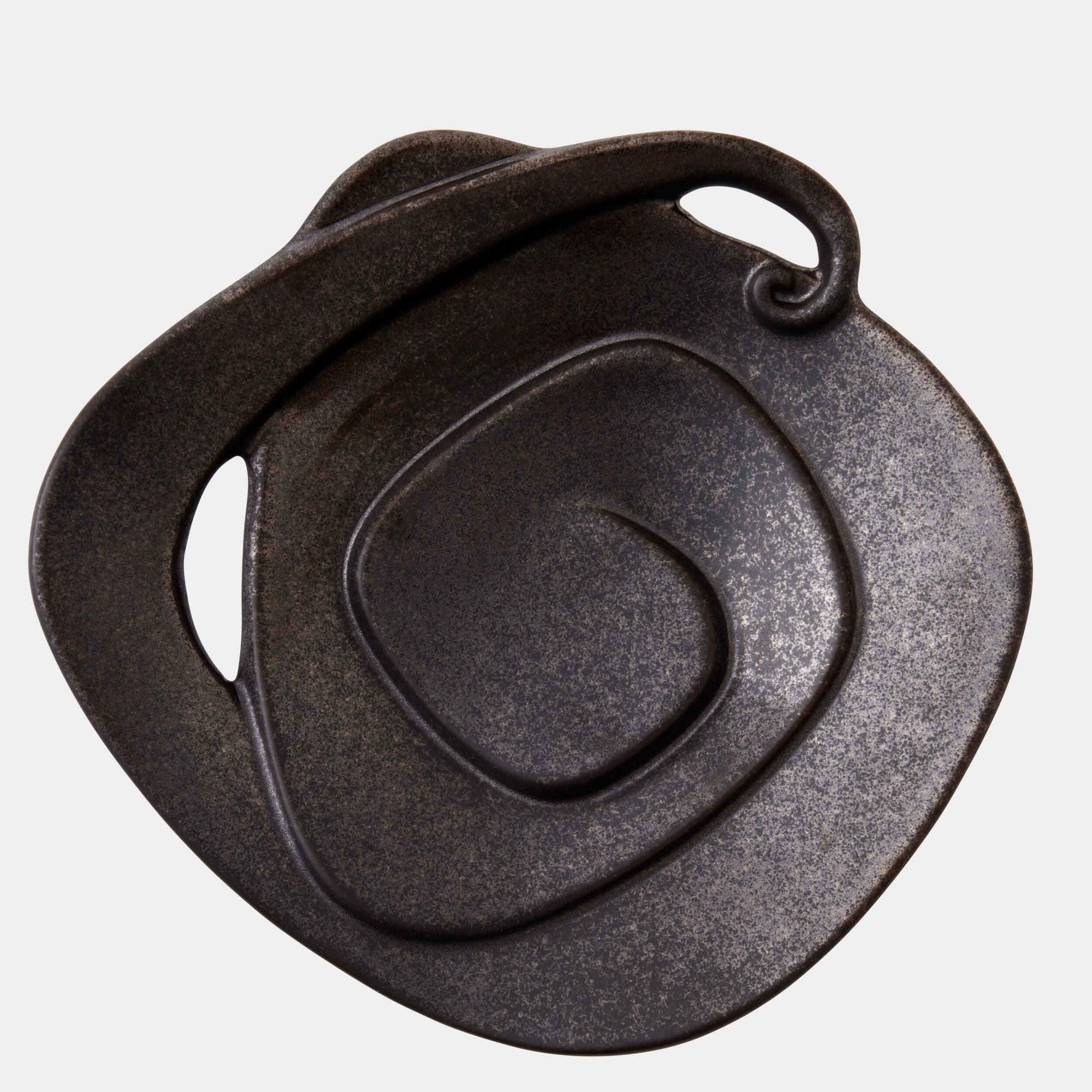 The Spiral Plate Black by Global Views features a black glaze, abstract spiral design, curved edge, and small looped handle, shown against a white background.