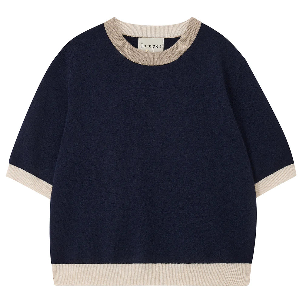 The Many Contrast T-Shirt by Jumper 1 2 3 4/CR2 is a navy cashmere short sleeve jumper with beige ribbed trim on the collar, cuffs, and hem, shown on a white background.