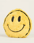 The Smiley Face Warmies Junior by Faire is a round, yellow plush toy with a fuzzy texture, black smiley face, and black outlines, designed for sensory comfort against a plain light background.