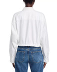 A person is seen from the back wearing the Denimist L/S FRONT TIE SHIRT WHITE S26, a crisp 100% cotton long-sleeve shirt with a point collar, tucked into blue high-waisted jeans against a plain white background.