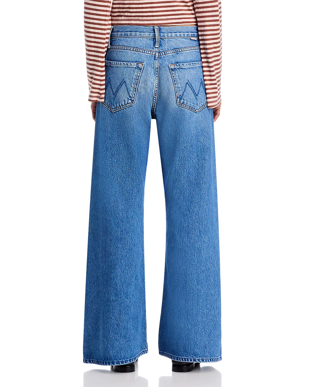 A person is shown from the back wearing Mother’s The Lemon Twist Sneak jeans in light blue with a high-rise, five-pocket style, stitched back pockets, frayed hems, and a red and white striped long-sleeve top.