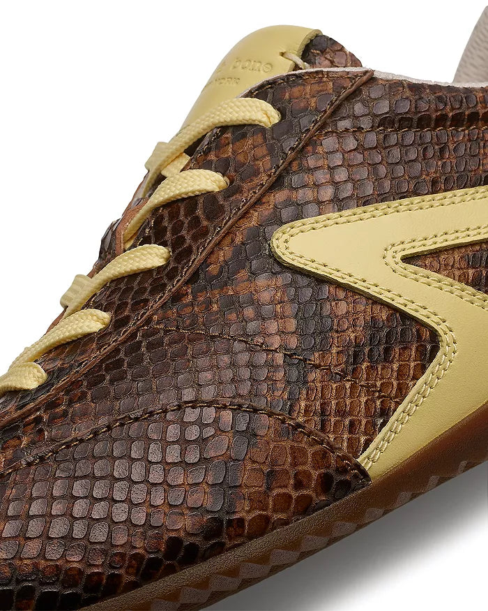 Close-up of the Rag & Bone retro runner slim ultra sneaker, featuring brown faux snakeskin texture with yellow leather accents, a bold yellow side detail, and matching yellow laces.
