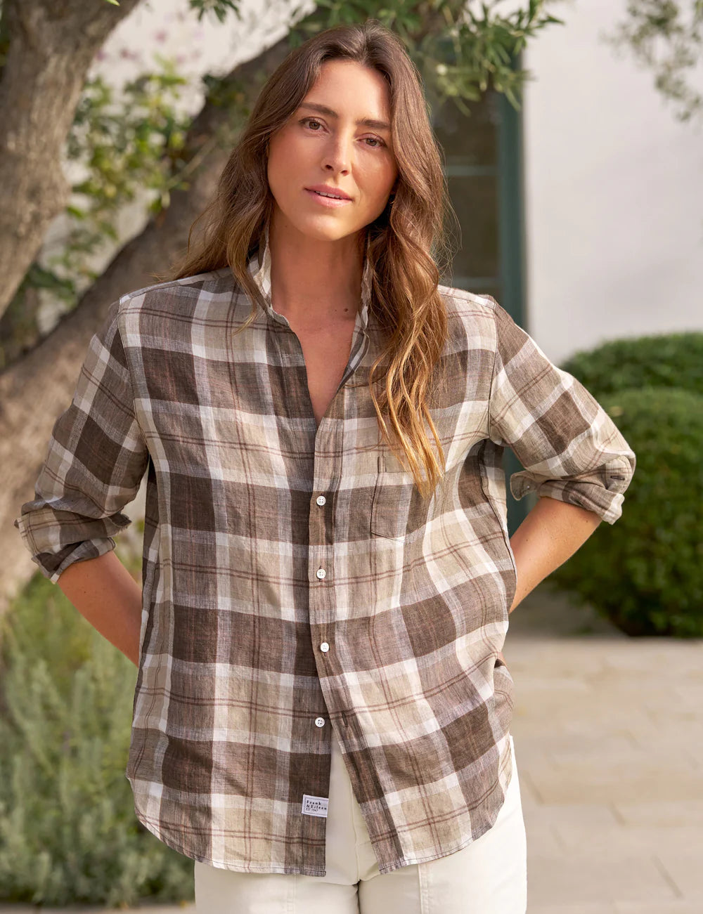 Frank &amp; Eileen relaxed fit cotton plaid shirt in outdoor garden setting with greenery and building in the background.