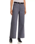 FRAME Le Slim Palazzo houndstooth pants with black belt and pointed boots, styled on white background.