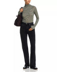 Rag & Bone black shawl-paneled turtleneck with matching jeans and accessories, styled against a white backdrop.