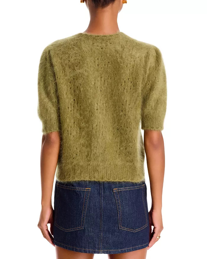 Olive green pointelle cashmere cardigan by FRAME paired with a dark denim mini skirt, back view.