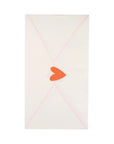 The Guest/Dinner Napkin by My Mind's Eye features a white rectangular design with soft pink diagonal lines and a red-orange heart seal, resembling an elegant envelope—perfect for special occasions.