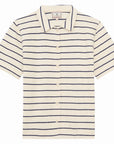 The Nicia Shirt by Ines De LA Fressange is a short-sleeve cream button-front shirt with a collar, featuring horizontal navy blue stripes and inspired by effortless Parisian style.
