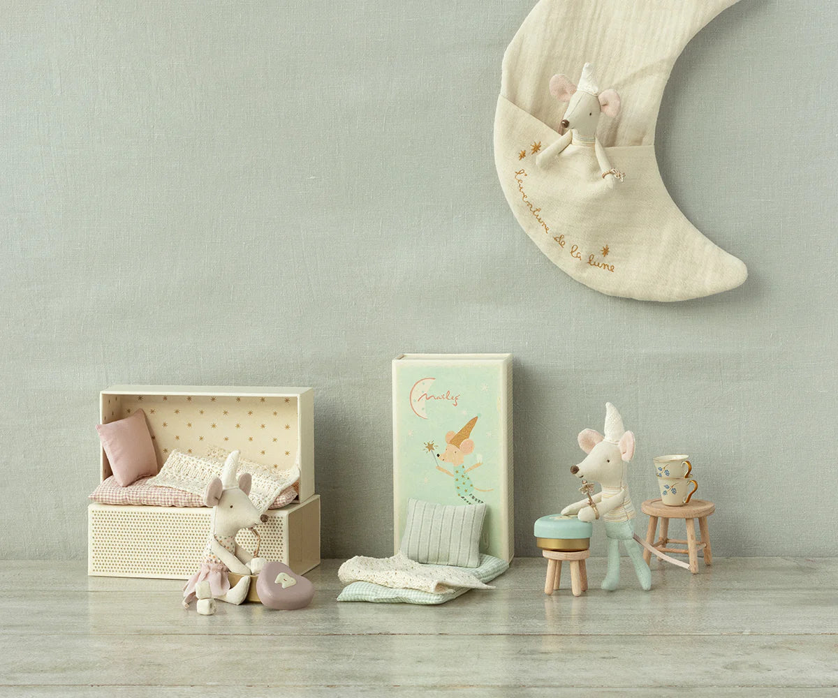 A charming scene features Maileg Tooth Fairy Mice by Maileg in a pastel room: one on a polka-dot bed, another with a mug on a stool, and two atop crescent moon decor. Delicate bedding, boxes, and a tiny tooth box complete the cozy setup.
