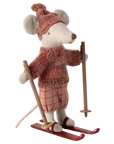 The Maileg Mouse by Maileg is a stuffed toy dressed in a red knit hat and sweater with plaid pants, standing on red skis and holding ski poles.