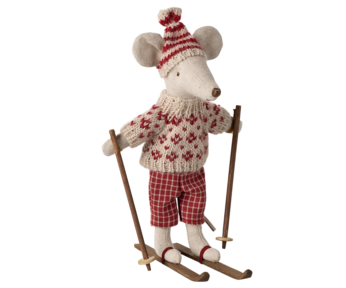 The Maileg Mouse by Maileg wears a red and white knit sweater, red plaid pants, and a matching winter hat while standing on wooden skis with poles, ready to join the mice family for snowy fun.
