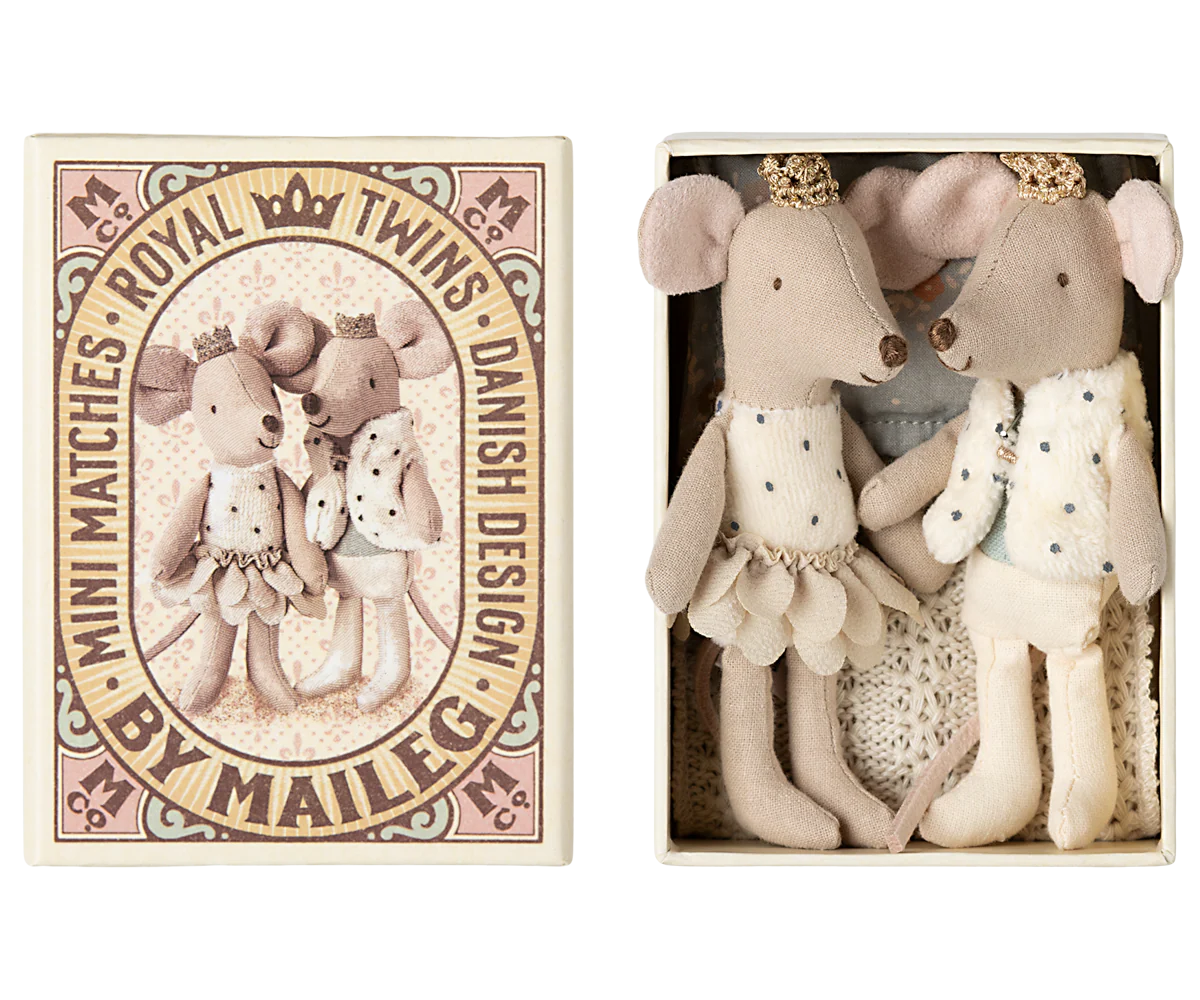Two Maileg Mouse dolls in matching royal outfits and crowns are side by side in a decorative box. The lid says “MINI MATCHES ROYAL TWINS DANISH DESIGN BY MAILEG” and features an illustration of the mice family.