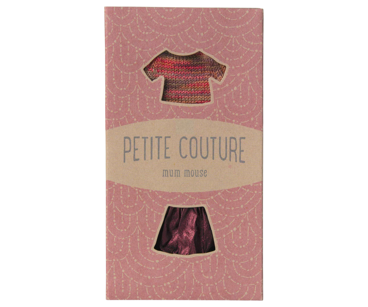 A pink Maileg box with window cutouts displays the Maileg Skirt &amp; Knitted Blouse set—adorable little mouse clothes for stylish play.