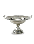 The Vintage 1795 Pedestal Bowl by Faire is a hand-made Italian pewter bowl with side handles, a wide reflective basin, and a round tiered base—offering timeless elegance.