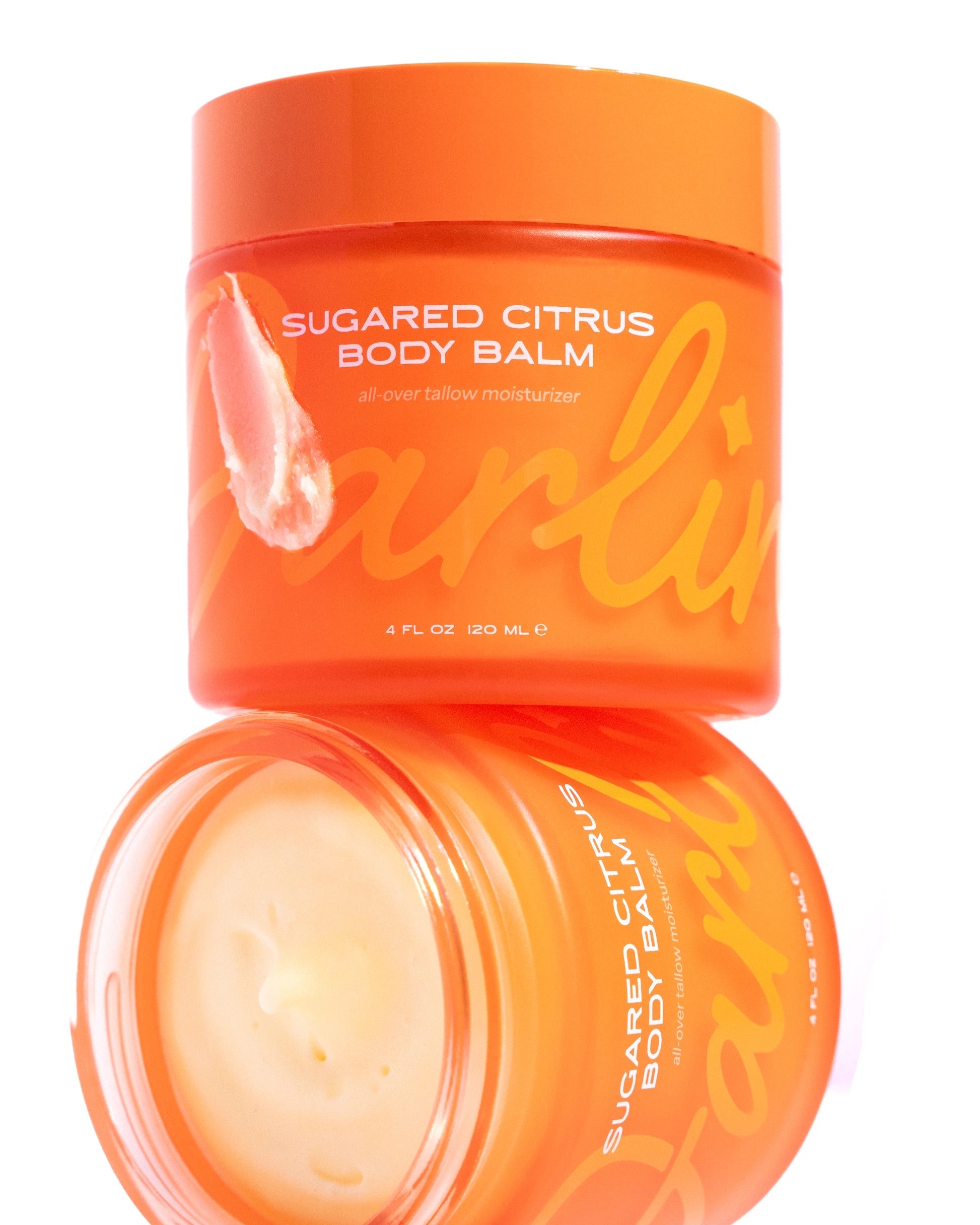 Two orange jars of Faire Tallow Body Butter Moisturizer are shown; one with the lid on, the other open to reveal creamy balm inside. Both display bold yellow text on their labels.