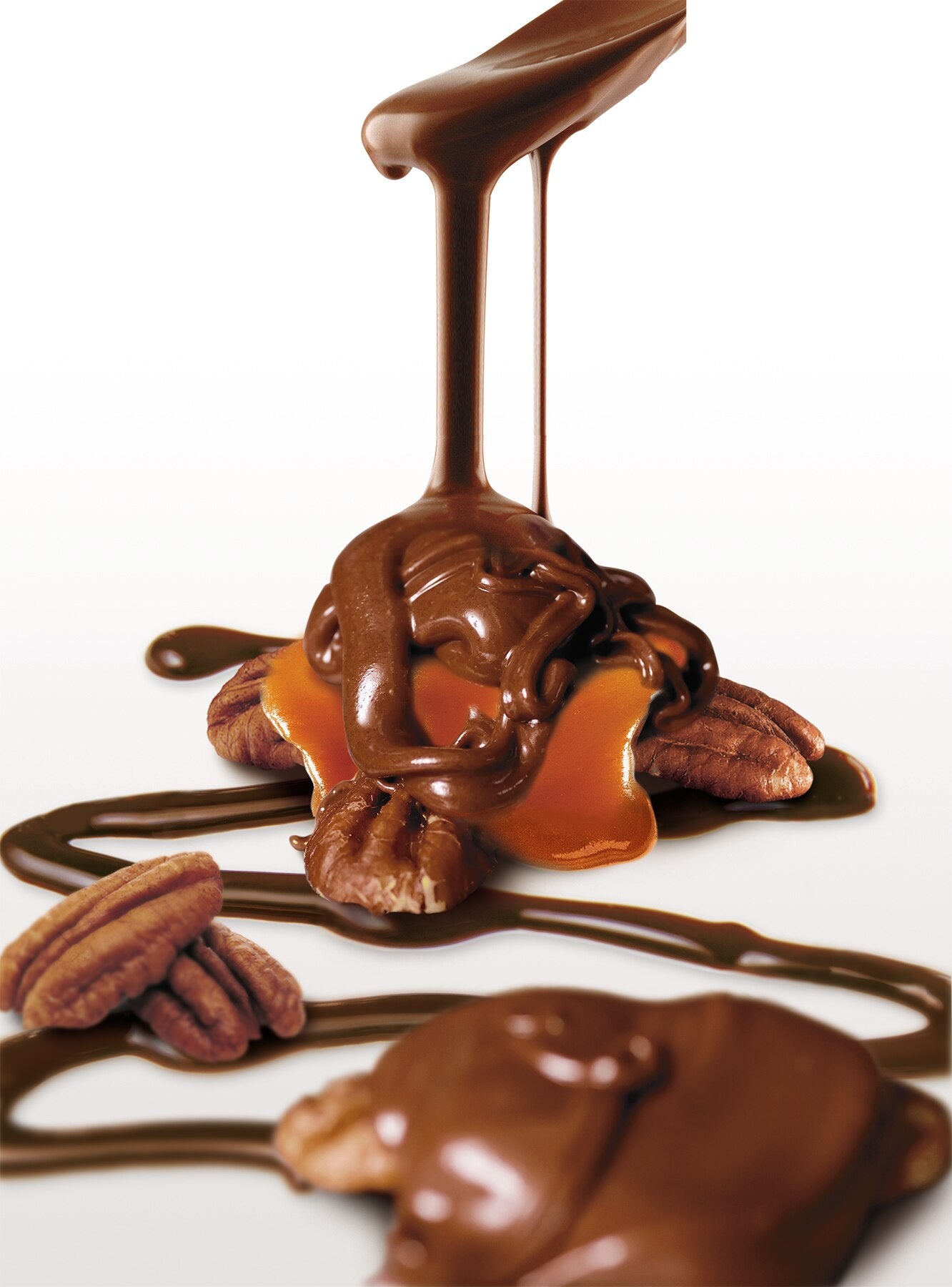 Velvety milk chocolate sauce cascades over pecans and caramel, crafting the decadent Faire LC Longhorns Milk Chocolate 6oz treat—Texas pecans and glossy caramel on a white backdrop.