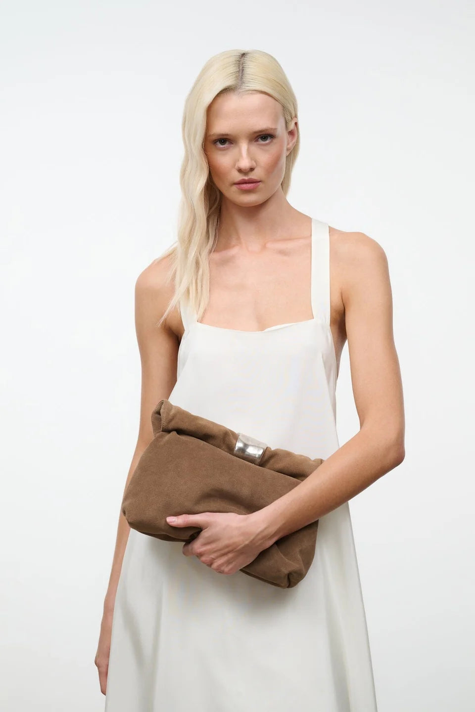 Staud Cuff Clutch with detachable strap, white dress, minimal style, plain white background.