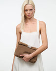 Staud Cuff Clutch with detachable strap, white dress, minimal style, plain white background.
