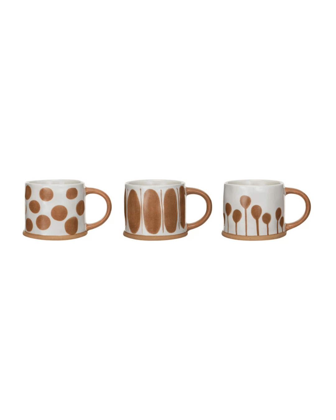 The Mug Assorted collection by Bloomingville features three stoneware mugs, each with a distinct pattern: one adorned with tan and cream polka dots, another featuring vertical ovals, and the third displaying abstract branches. All mugs highlight a raw clay base and handles, presenting a simple yet artistic design.