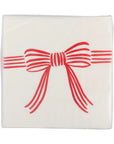 The MME Napkin by Faire is a white napkin adorned with a design of a red bow and horizontal lines that extend from both sides of the bow.