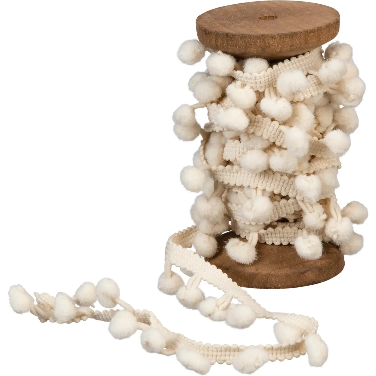 The Faire Christmas Ribbon features cream-colored pom pom trim elegantly wrapped on a wooden spool, with some trim unwound—making it ideal to pair with tinsel garland for charming Christmas decor.