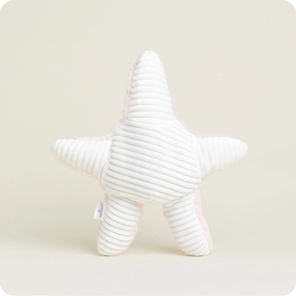 The Faire Starfish Warmies is a white, ribbed microwavable plush pillow with a light pink border, shaped like a starfish and shown upright against a light background, providing soothing warmth for relaxation.