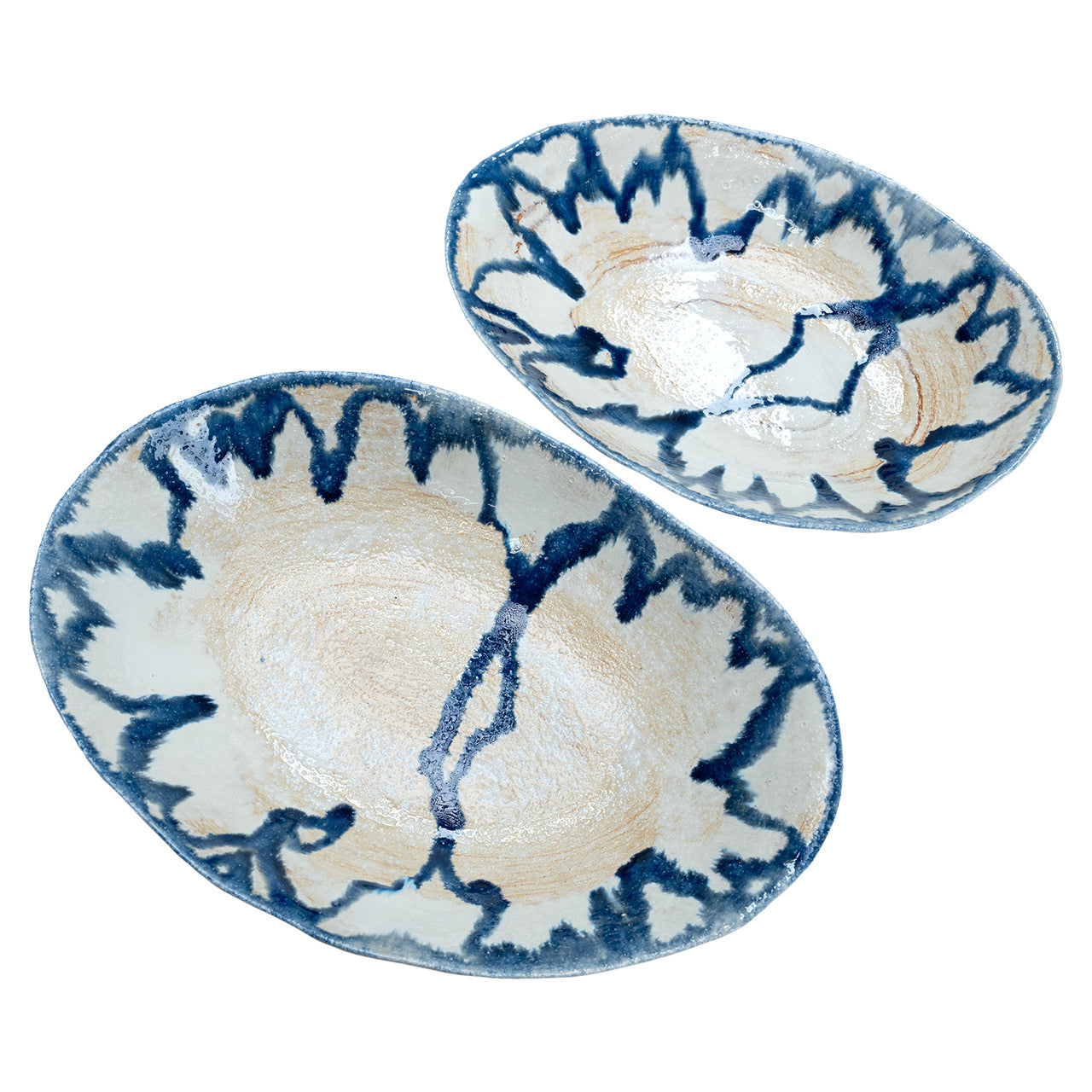 The Demario Bowls by The Import Collection feature two oval ceramic pieces with cream bases and dark blue abstract patterns, adding a hand-painted, artistic accent to your handcrafted home decor.