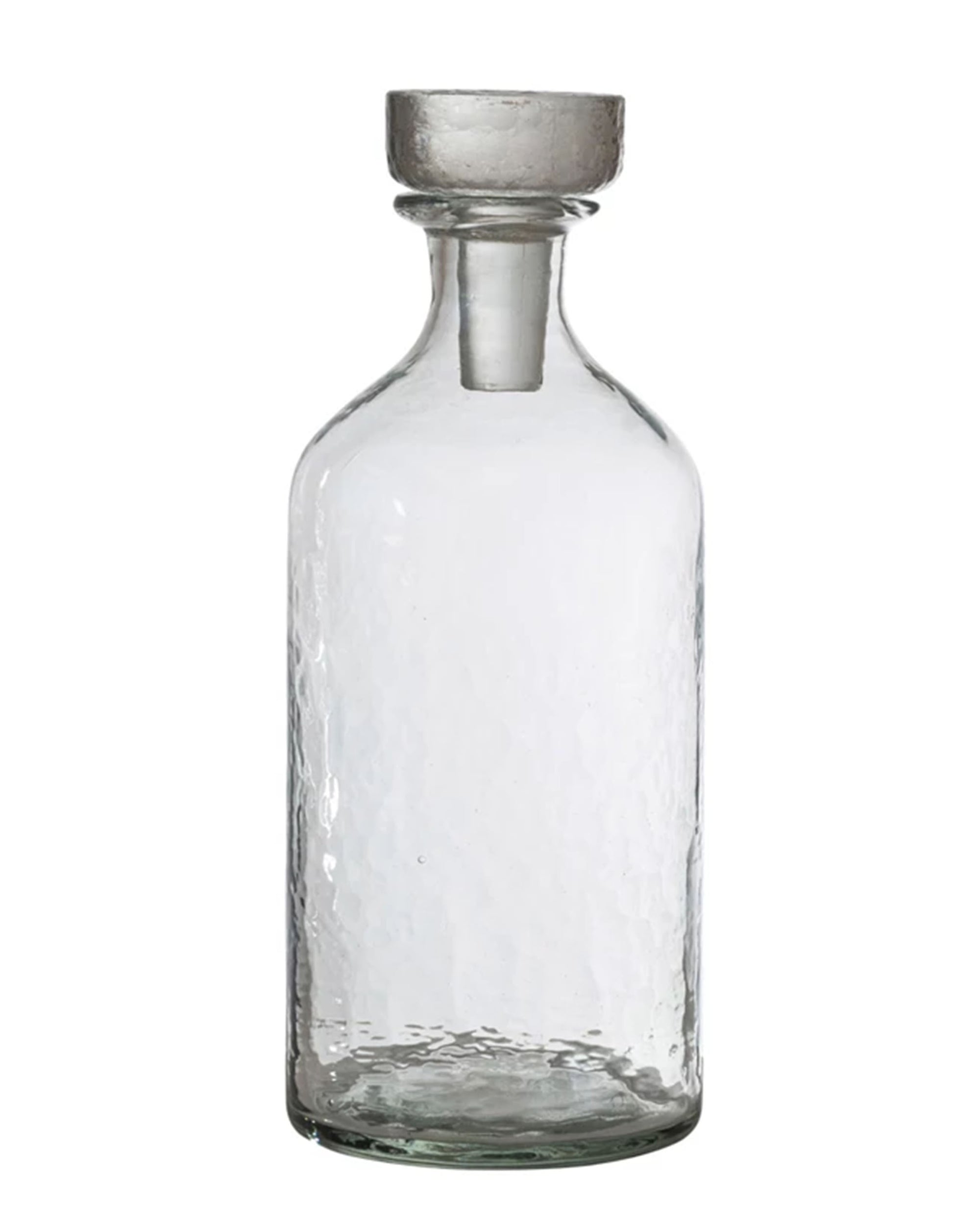 The Creative Co-op Decanter 20oz features clear glass, a narrow neck, round flat-topped stopper, and a textured surface—an essential for modern hosts—shown against a plain white background.