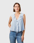 DOEN Hilda Top in organic cotton with lace ruffles, styled with blue jeans against a neutral background.