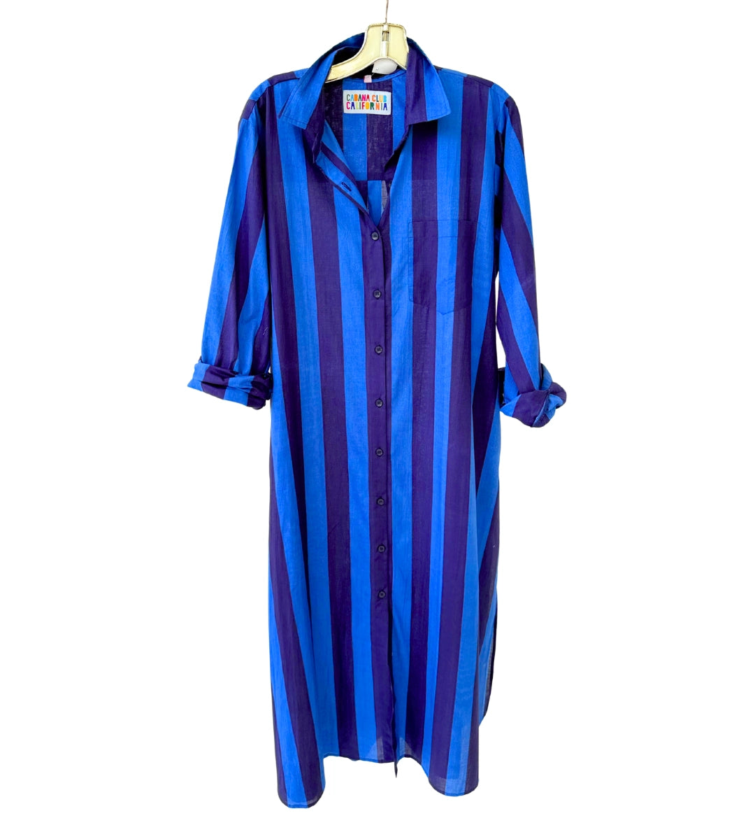 The Faire Surf Stripe Shirt Dress features vertical blue and purple stripes, rolled-up long sleeves, and a left chest pocket, offering effortless style that goes beyond the beach.