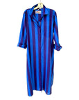 The Faire Surf Stripe Shirt Dress features vertical blue and purple stripes, rolled-up long sleeves, and a left chest pocket, offering effortless style that goes beyond the beach.