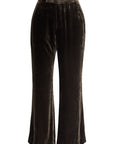 A pair of Crop Flare Velvet Trousers by FRAME in a dark brown color, displayed against a white background. These midweight trousers feature a high waist and a smooth texture.