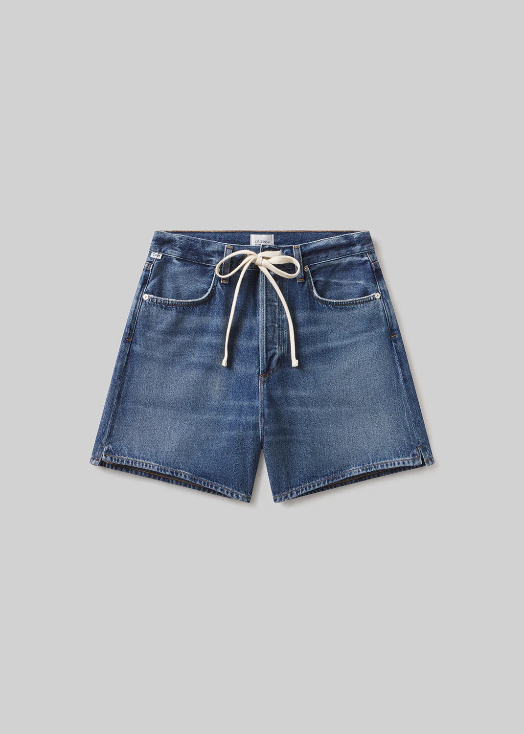 The brynn drawstring short in avant (lightwt vintage) by Citizens Of Humanity/AGOLDE features a relaxed fit, front pockets, visible stitching, and a white drawstring waist, shown flat on a plain light gray background.