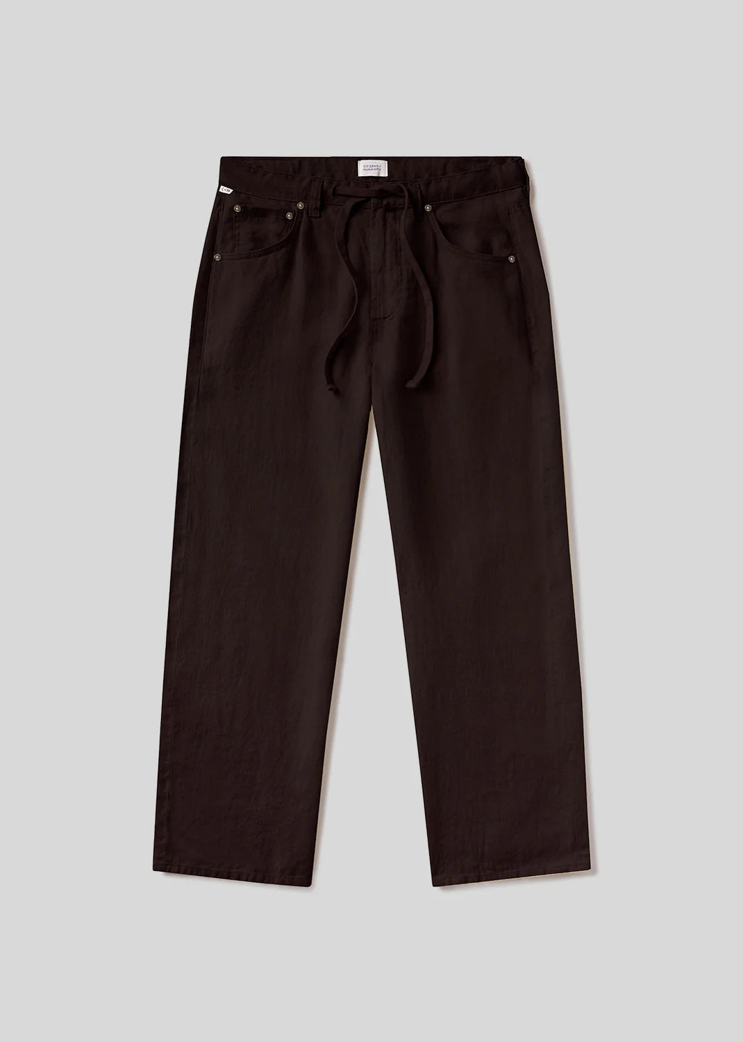 The brynn drawstring trouser in linen by Citizens Of Humanity/AGOLDE is a pair of relaxed fit, dark brown pants with a drawstring waist and side pockets, displayed flat on a light gray background.
