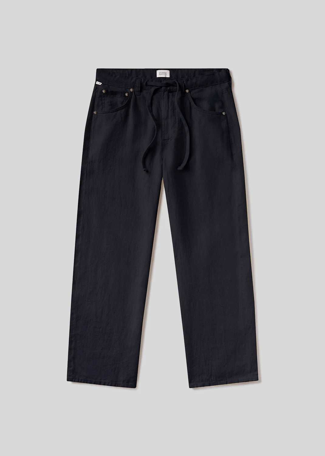 The brynn drawstring trouser in linen by Citizens Of Humanity/AGOLDE, shown in black with a relaxed fit, front and back pockets, and a drawstring waist, is displayed against a plain light gray background.