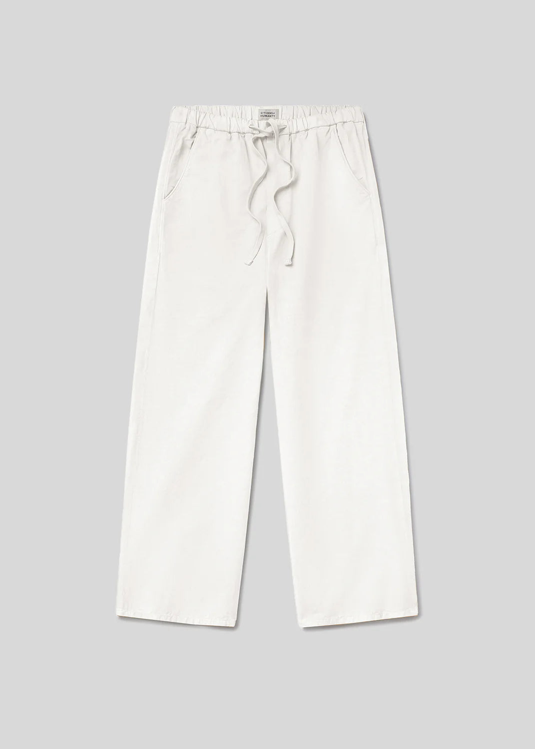 The aurora pull on pants by Citizens Of Humanity/AGOLDE are versatile women’s pants in a breathable cotton flax blend with an elastic waistband, drawstring ties, and side pockets, shown flat on a plain light gray background.