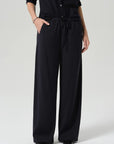 Aurora Pull On pants in Portofino Twill by Citizens of Humanity, styled with black pointed shoes and dark shirt.