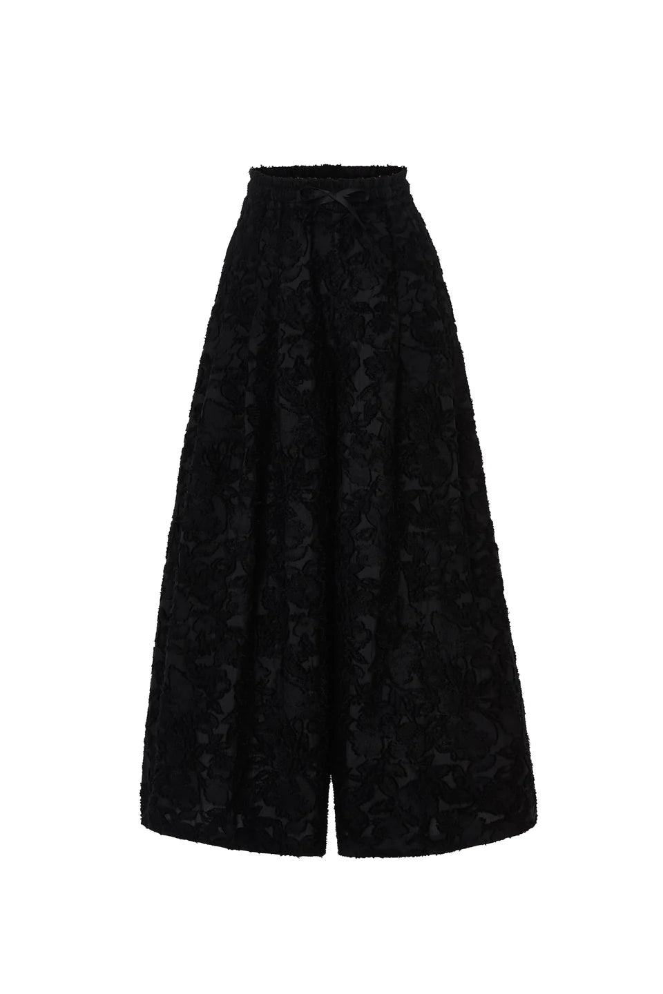 The Psophia Palazzo Wide Leg Trouser features a high-waisted, wide-leg silhouette and a textured floral jacquard pattern in black, embodying minimalist style and shown against a white background.