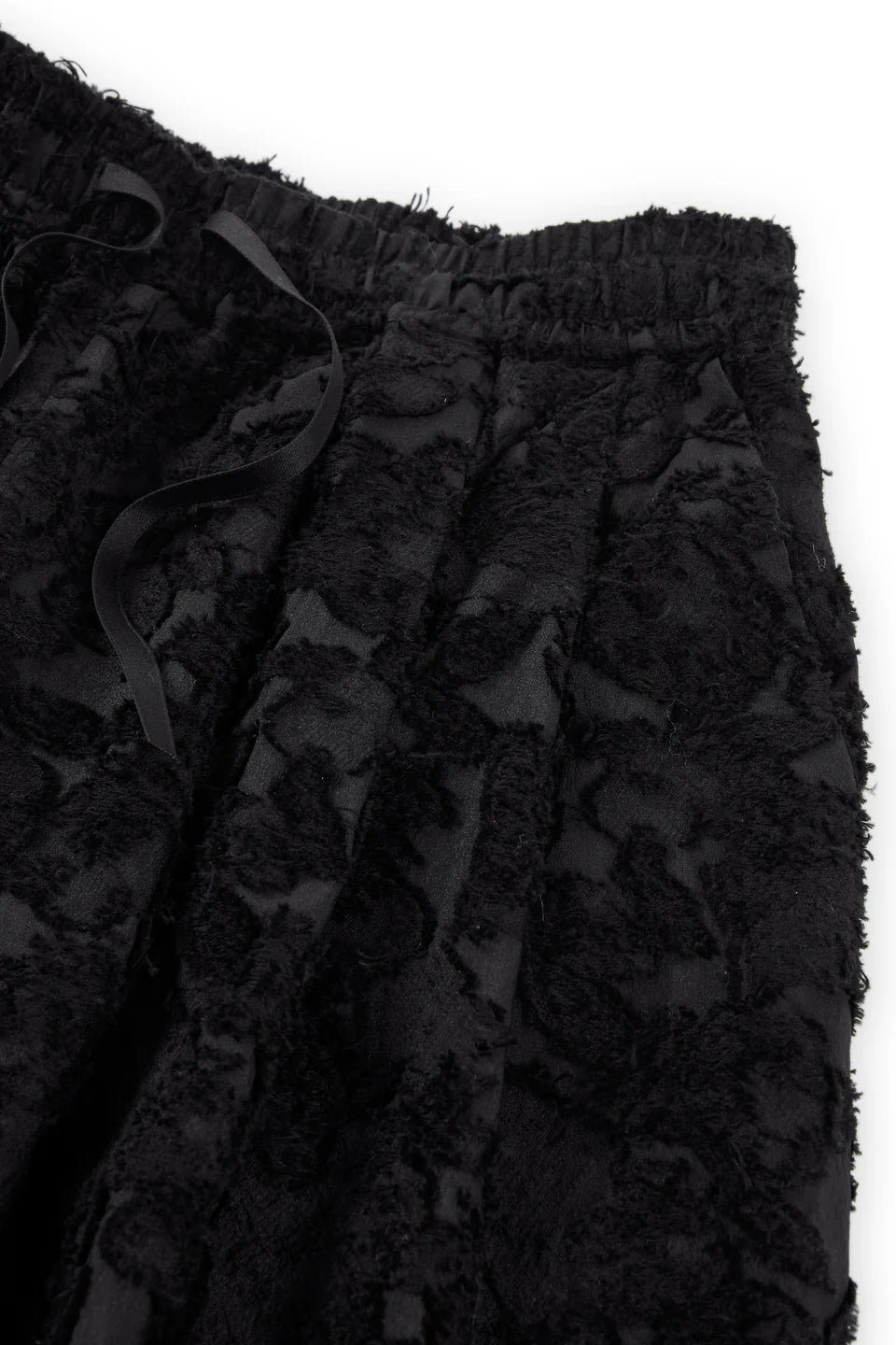 Close-up of Psophia’s Palazzo Wide Leg Trouser, featuring a minimalist design with an elastic waistband, drawstring, and soft, fuzzy fabric.