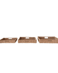 Three Creative Co-op Hand-Woven Bankuan Trays with handles, arranged side by side on a plain white background. Each tray is identical in size and design, featuring a woven texture and a natural brown color—perfect for adding farmhouse decor to any space.