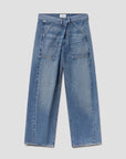 The Ines Utility Trouser by Citizens of Humanity/AGOLDE features wide-leg, high-rise medium indigo denim with front patch pockets, visible seams, and a straight cut, made from regenerative cotton denim and shown on a light gray background.